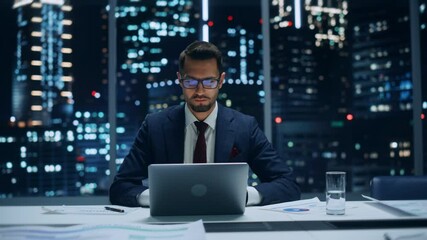 Leinwandbilder - Successful Handsome Businessman Working on Laptop Computer in Big City Office Late in the Evening. Finance Investment Analyst Checking Line and Pie Graphs from Project Management Report. Zoom In Shot.