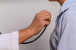 © Johnstocker - a doctor using a stethoscope to check a patient's heart