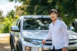 © Johnstocker - A man wearing a white shirt and standing in front of a car