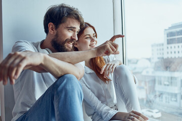 Wall Mural - Man and woman sitting on the windowsill love Lifestyle