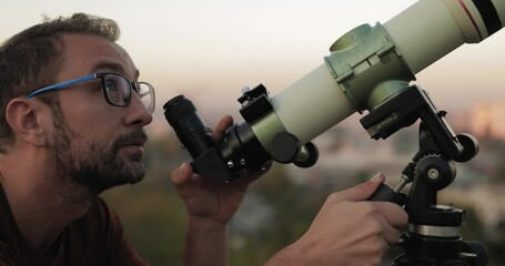 Wall Mural - astronomer with a telescope watching at the stars and moon.