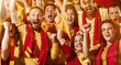 © master1305 - Spanish emotive football, soccer fans cheering their team with a red scarfs at stadium stands. Concept of sport, emotions, team event, competition.