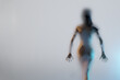 Blurred silhouette of young sexy woman in shower behind glass. 3D rendered illustration.