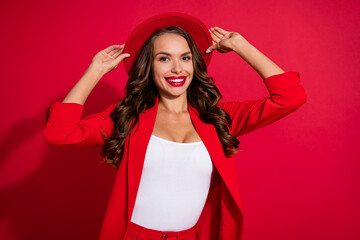 Wall Mural - Photo of gorgeous charming young lady dressed suit blazer arms headwear smiling isolated red color background