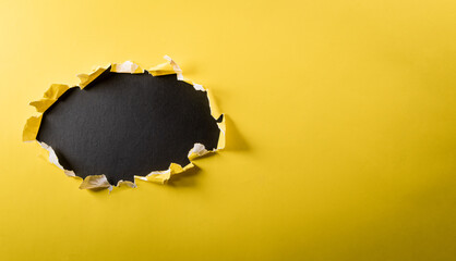 Wall Mural - Top view of yellow torn paper on blackboard background. Black Friday composition.