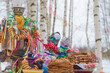Festive decor for Maslenitsa on the table: pancakes, bagels, a samovar, a doll with ribbons. Russian folk traditions