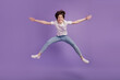 © Tetiana - Full size photo of excited young girl jump air have fun travel dream isolated on violet color background