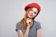 © SHOTPRIME STUDIO - beautiful woman in a striped t-shirt red lips gesture with his hands light background