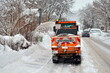 Winterdienst, Räumdienst mit Schneeschleuder bei Schneefall auf Straße und Gehweg in Stadt