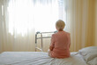 © Evrymmnt - Elderly woman in nursing home room holding walking frame with wrinkled hand. Senior lady grabbing metal walker's handles. Interior background, copy space, close up.