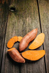 Organic orange sweet potato. Raw sweet potatoes or batatas. vertical image. top view. place for text