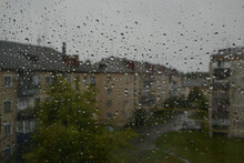Raindrops On The Window, Cloudy Summer Day And Wet Houses In The Background, Rain