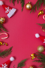 Wall Mural - christmas red background with decorative elements and green branches flat lay copy space