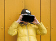 © Scopio - Girl in yellow jacket with VR headset