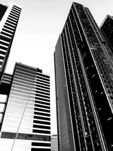 Grayscale And Low Angle Photography Of High-rise Buildings