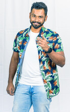 Man Wearing Floral Shirt Standing Against Light Background