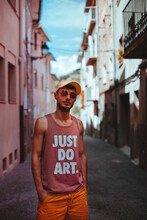 Portrait Of Man In Shirt With Text "Just Do Art" Standing In An Alley