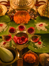 Red Rose Petals On Diya With Five Candle Holders