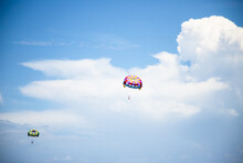 Two People Parachuting In The Air