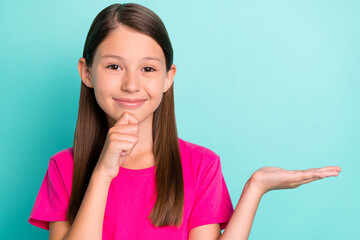 Sticker - Photo of happy brunette haired minded girl hold hand empty space display object isolated on teal color background