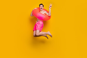 Sticker - Full size profile side photo of young man happy smile show peace cool v-sign swimming ring isolated over yellow color background