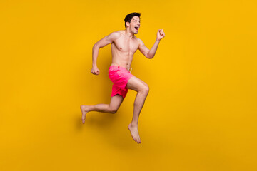 Poster - Full length body size view of attractive cheerful motivated guy jumping running isolated over shine yellow color background