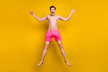 Poster - Full length photo of cool millennial guy jump wear pink shorts isolated on yellow background