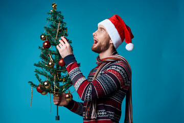 Wall Mural - emotional man in a santa hat holding a banner holiday isolated background