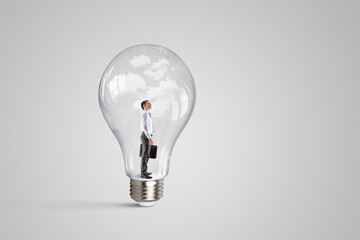 Wall Mural - Business man standing inside a light bulb