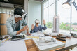 Team Architect or Engineer designer wearing VR headset for BIM technology working together design 3D model building in office. Technology futuristic virtual reality design.