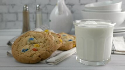 Wall Mural - Pouring milk into a glass next to gourmet sugar cookies
