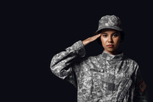 Saluting African-American Female Soldier On Dark Background
