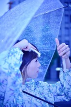 Portrait Of Woman Holding Blue Umbrella