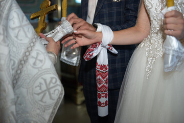 Bride and groom at traditional  christian orthodox wedding ceremony at the church listening to priest and holding candles