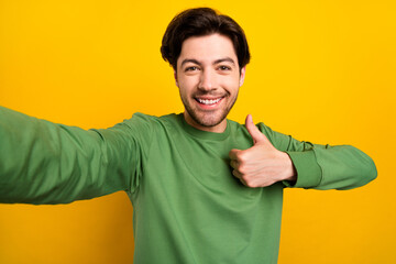 Sticker - Photo of young cheerful happy man make selfie thumb up recommend smile isolated on yellow color background