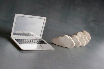 Wall Mural - cloud computing concept. laptop and white clouds.