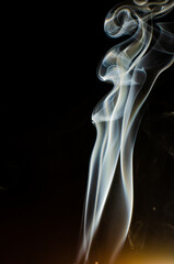 Sticker - Vertical shot of smoke on a dark background