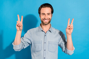 Sticker - Portrait of attractive cheerful man employer showing double v-sign isolated over bright blue color background