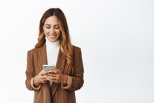 Smiling Corporate Woman Order Taxi In App, Chatting In Messanger App On Smartphone, Looking At Her Phone Screen With Pleased Face, White Background