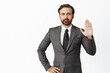 Image of angry boss, raising hand objection gesture. Denying something, saying no and tell to stop, standing over white background