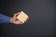 © Towfiqu Barbhuiya  - man hand hold a sticky note against gray background