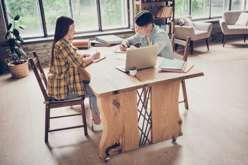 Poster - Full size photo of two focused concentrated university students leaning prepare homework exam writing notebook