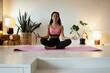 © opolja - Young black woman doing yoga at home in the lotus position.