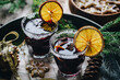 Tray with Swedish glögg in glass and ginger cookies . Traditional Nordic drink. Mulled wine with spices, orange and raisins.