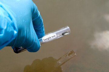 Wall Mural - Collect samples of wastewater from industrial canals in test tube