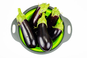 Wall Mural - Clean washed eggplant for cooking in colander. Studio Photo.