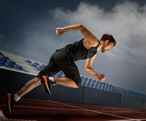 Wall Mural - Man sprinter leaving starting blocks