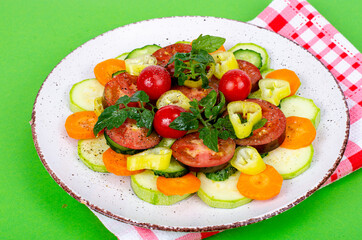 Wall Mural - Healthy food concept. pPlate with chopped fresh vegetables on bright background. Studio Photo