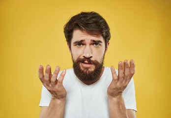 Canvas Print - Man in a white t-shirt irritated facial expression close-up