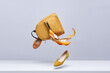 © Tatsiana - Women's shoes and accessories flying in the air on a light background. Fashionable women's items. Fashionable and modern womens handbag and shoes.